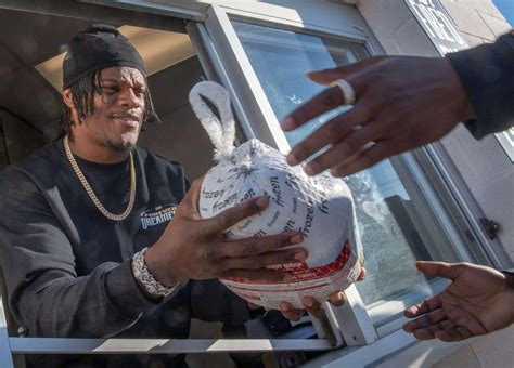 Ravens QB Lamar Jackson helps distribute turkeys for Carroll County Food Sunday in Westminster